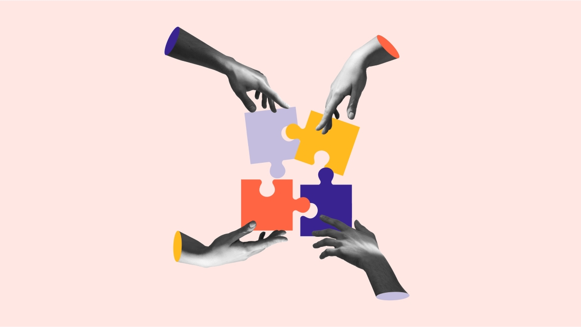 Four collaborative hands assembling puzzle pieces into a perfect square