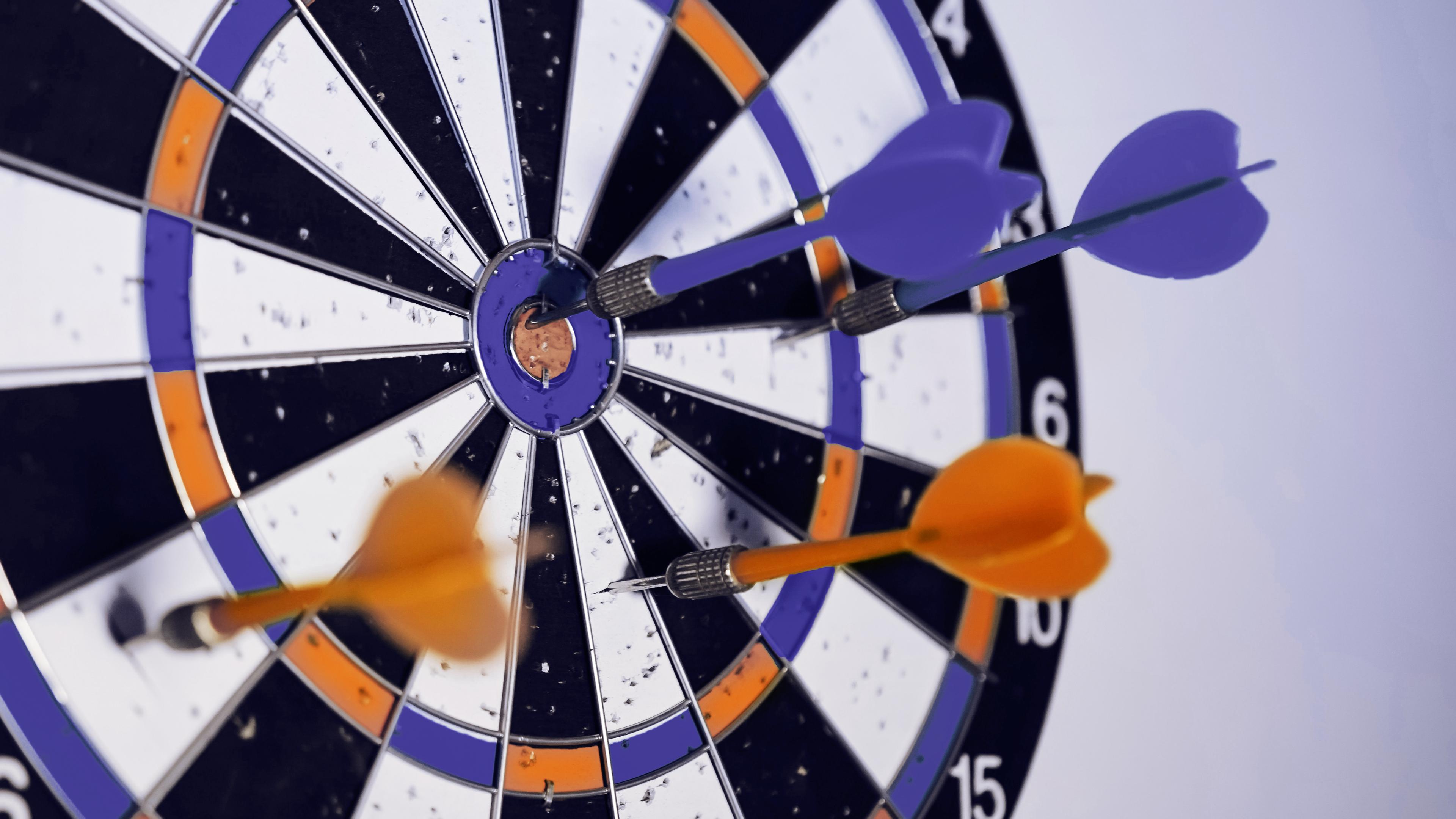 Dart board with thrown darts